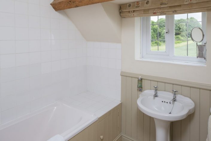 The family bathroom on the first floor has fabulous views across the surrounding fields.
