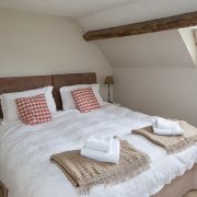 Bedroom 2 on the first floor has exposed beams, lovely throws and an en suite shower-room.