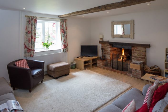 The spacious sitting-room has a cosy open fire.